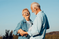 Older couple laughing together outdoors, lifestyle for UMF 26+ MGO 1282+ Manuka honey