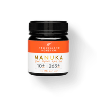 UMF 10+ MGO 263+ Manuka honey 250g jar with orange Arabic-English label on white