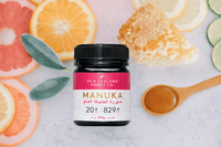 UMF 20+ MGO 829+ Manuka honey flat-lay with citrus slices, honeycomb and a sage leaf