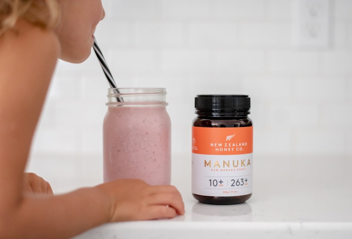 Girl drinkings smoothie with New Zealand Honey Co. Manuka honey UMF 10+ in it