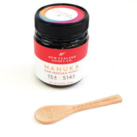 Branded bamboo Daily Spoon resting beside a UMF 15+ Manuka honey jar