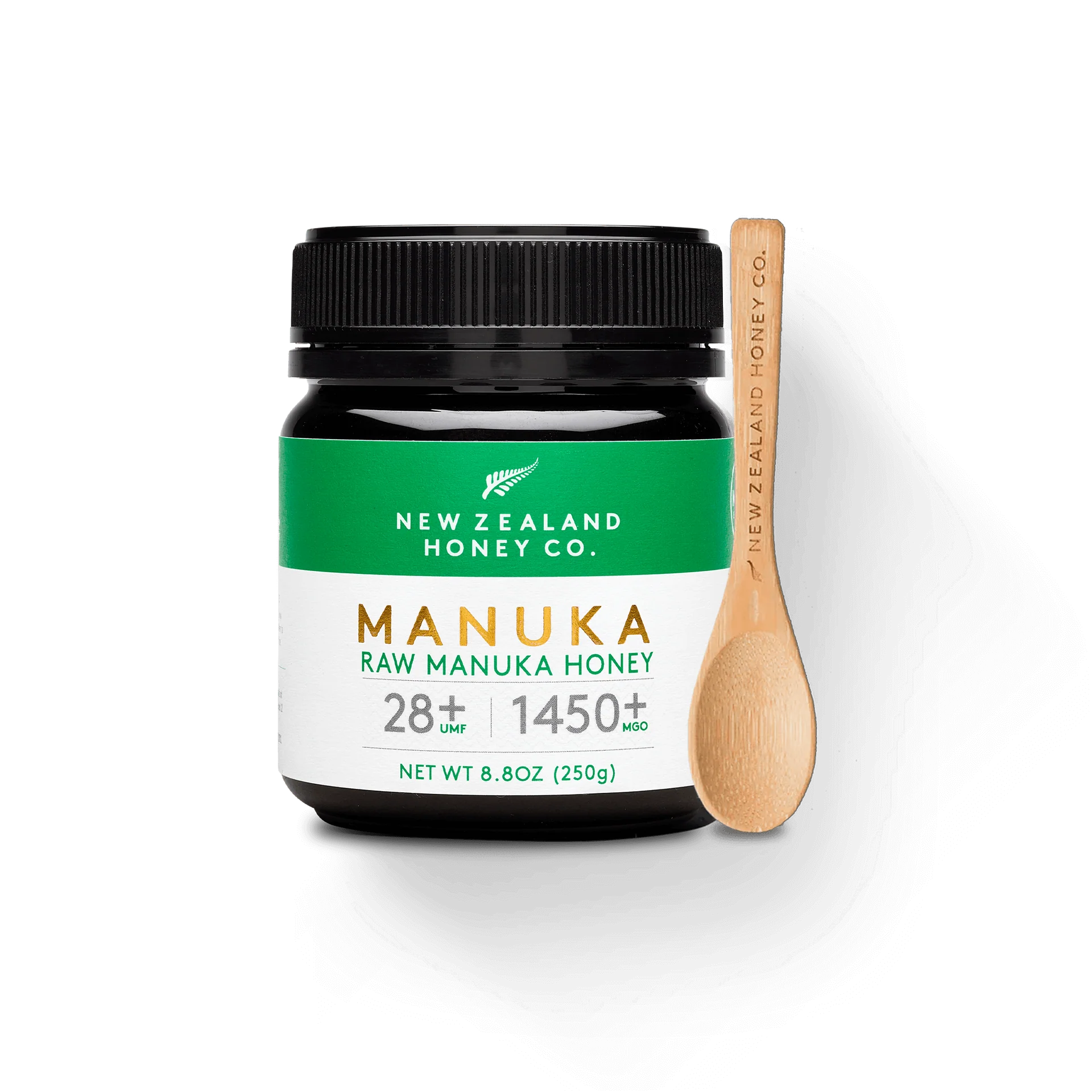 UMF 28+ MGO 1450+ Manuka honey 250g jar with branded bamboo honey spoon on white